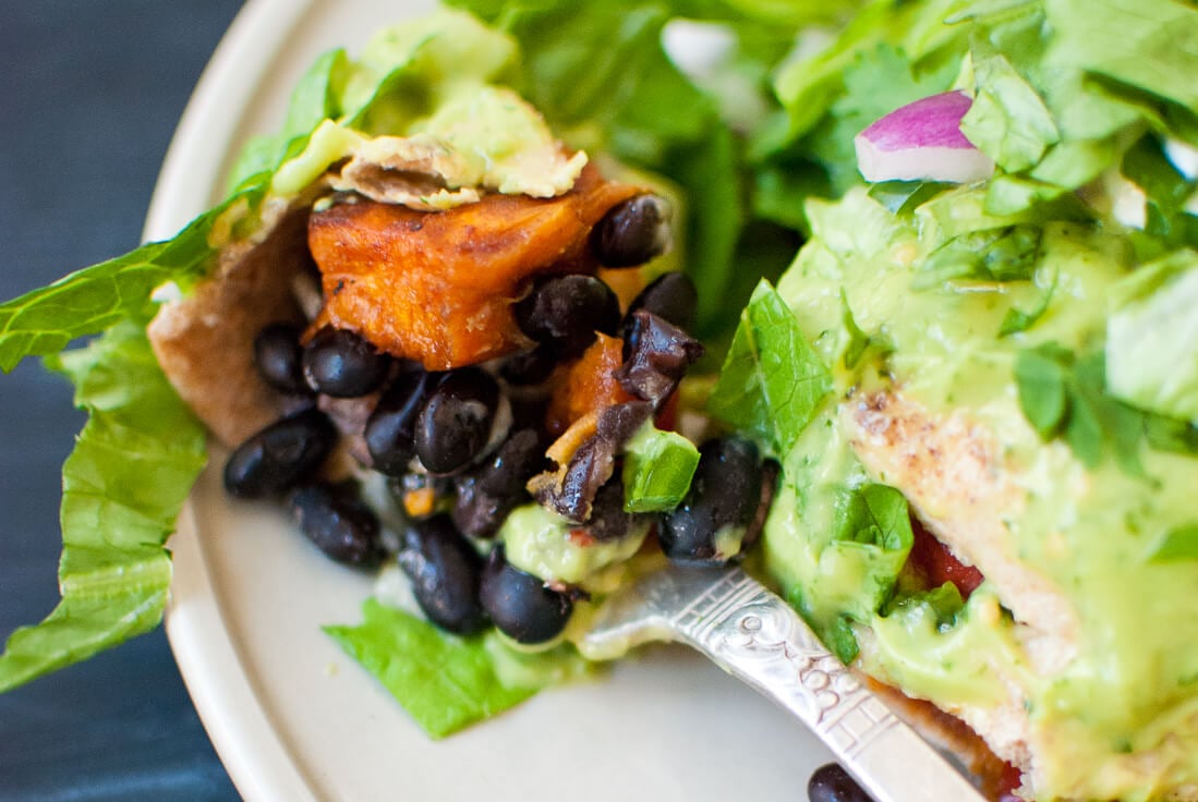 bite of burrito with avocado sauce bite of burrito with avocado sauce